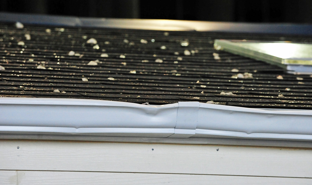 Hail damage to aluminum gutter