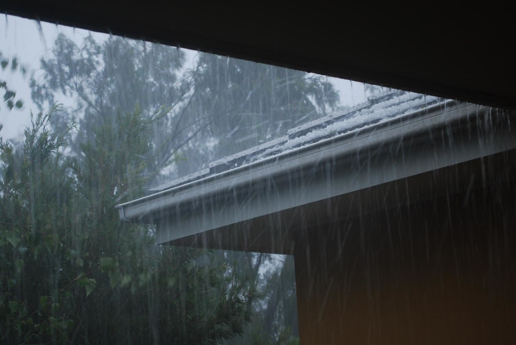 Roof covered in hail, heavy rain